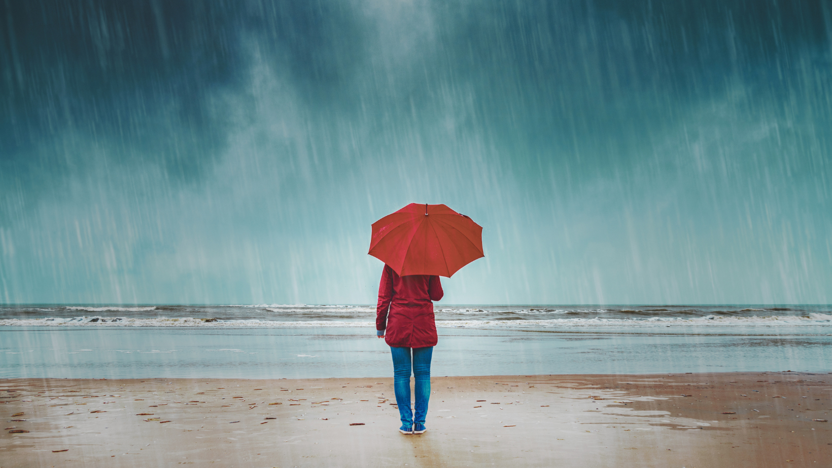 Winter person standing in the rain with umbrella