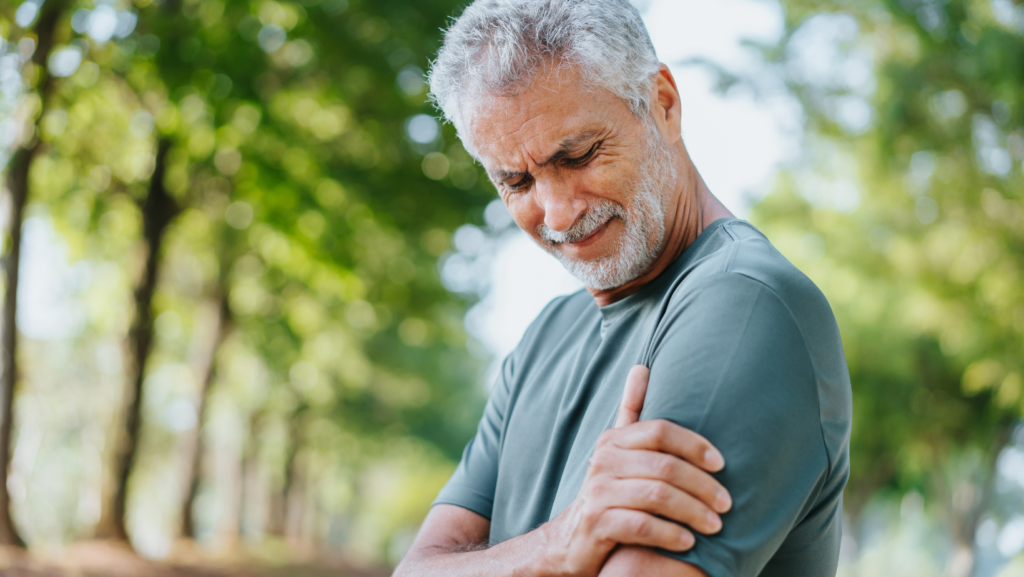 Man holding his shoulder with pain